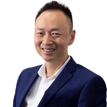 Dr Pek Ang – Specialist Psychiatrist at Mind-Care Newcastle, wearing a navy suit and white shirt.